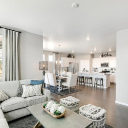 A large open concept great room, looking into the dining room as well as the kitchen.